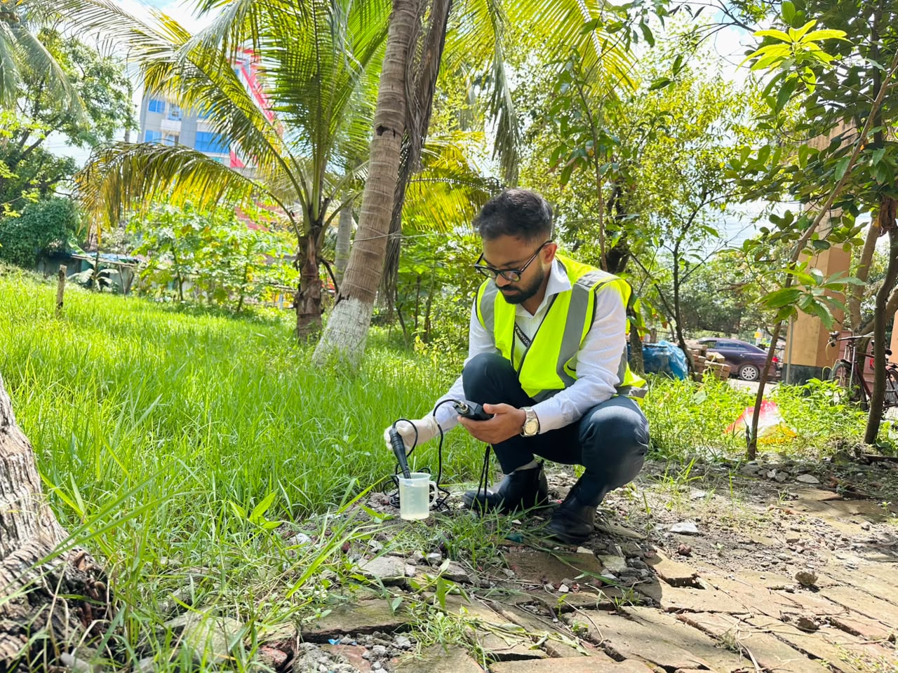 SRCL specialists conducting a field assessment near a river in Bangladesh as part of project planning.